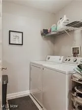 Laundry area featuring washer and dryer and baseboards