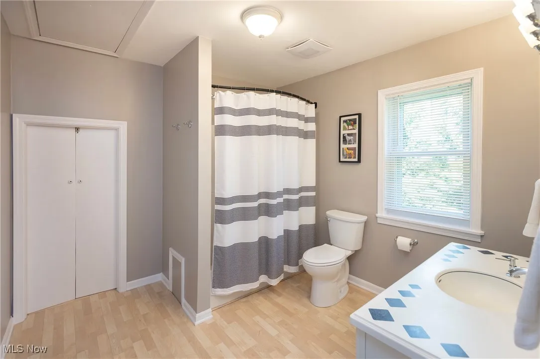 Large Bathroom with vanity, shower-tub combo and access to attic storage space or closet for 3rd bedroom