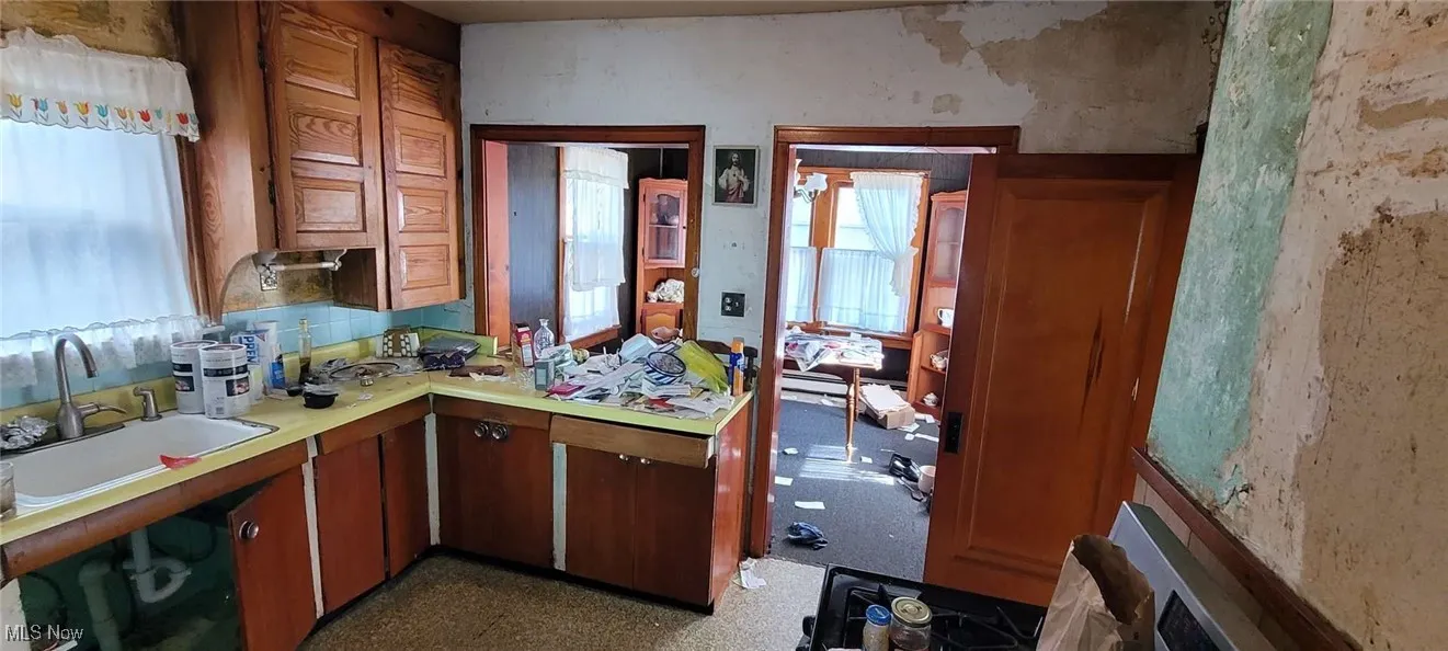 Kitchen featuring light countertops and brown cabinets