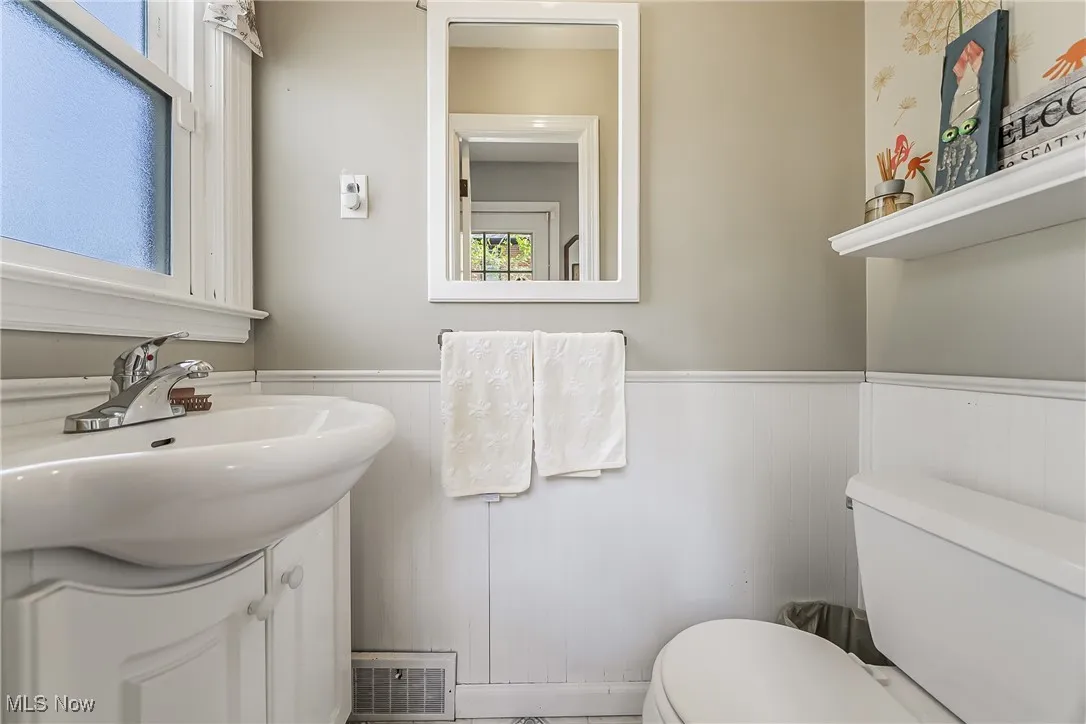 Bathroom featuring vanity and a wainscoted wall