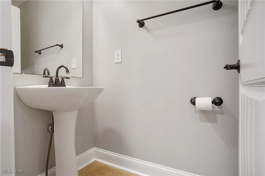 Bathroom featuring light tile patterned floors and baseboards