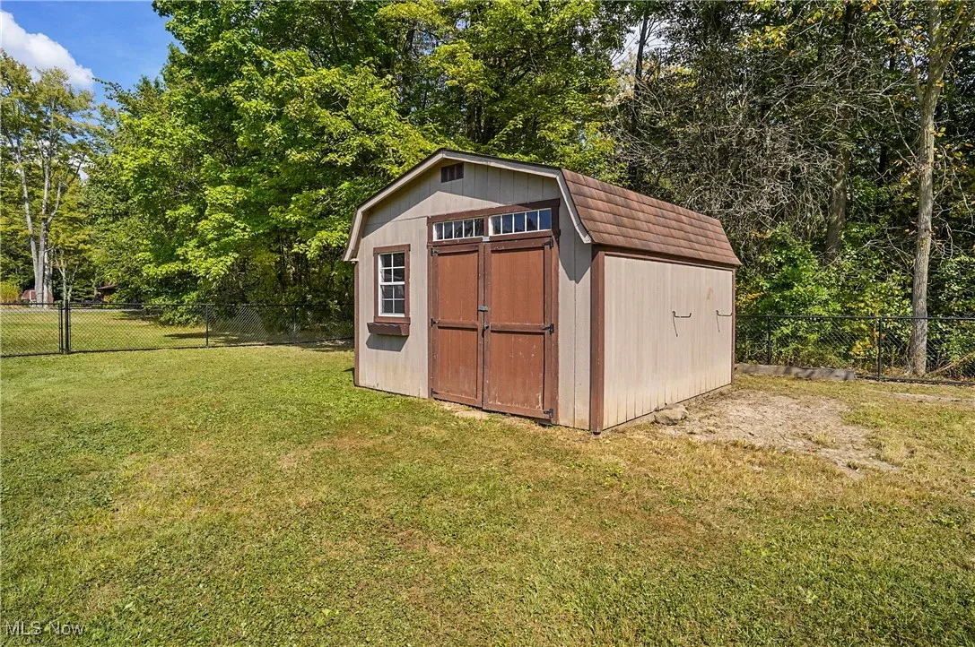View of shed featuring view of scattered trees