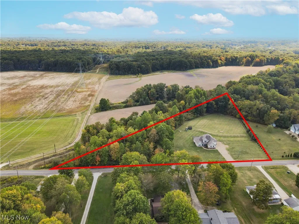 Aerial view of sparsely populated area with property parcel outlined and a heavily wooded area( All property boundaries are estimated. Buyer to do due diligence)