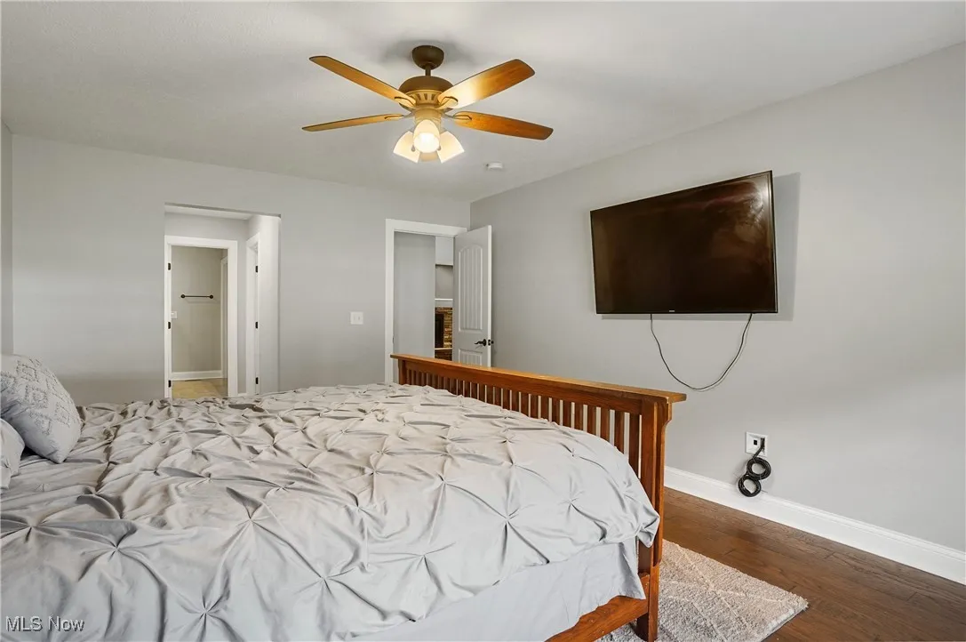 Bedroom featuring dark wood-style floors and ceiling fan