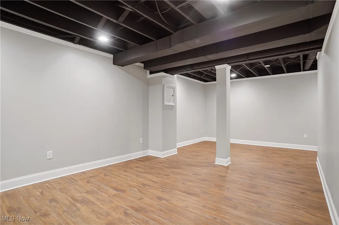 Finished basement with baseboards and light wood-style floors