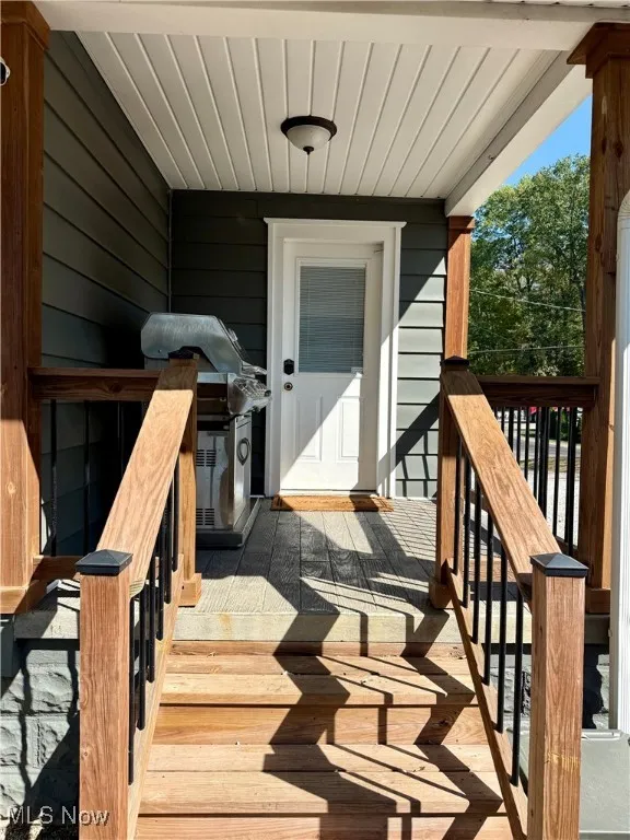 Doorway to property with a deck