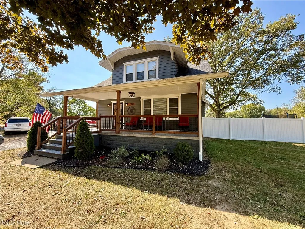 View of front of house featuring covered porch and a front lawn