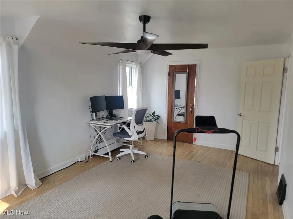 Home office with light wood-type flooring