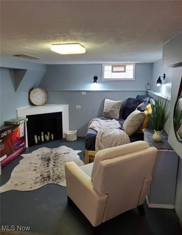 Living area featuring a textured ceiling