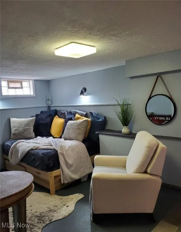 Living area featuring a textured ceiling