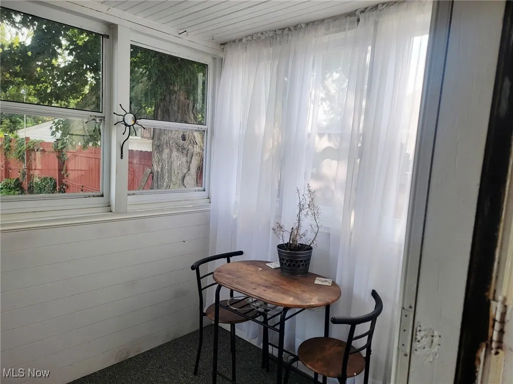 Sunroom featuring carpet flooring