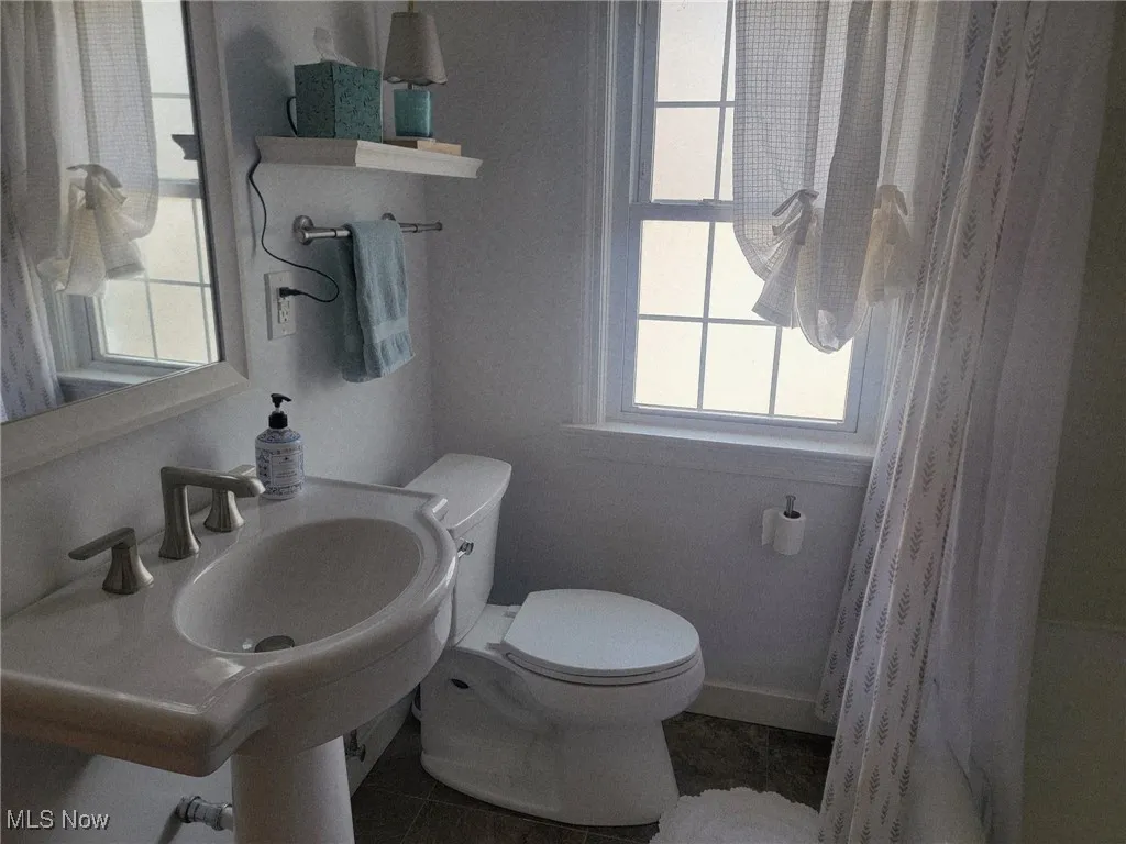 Bathroom with tile patterned flooring and shower / tub combo