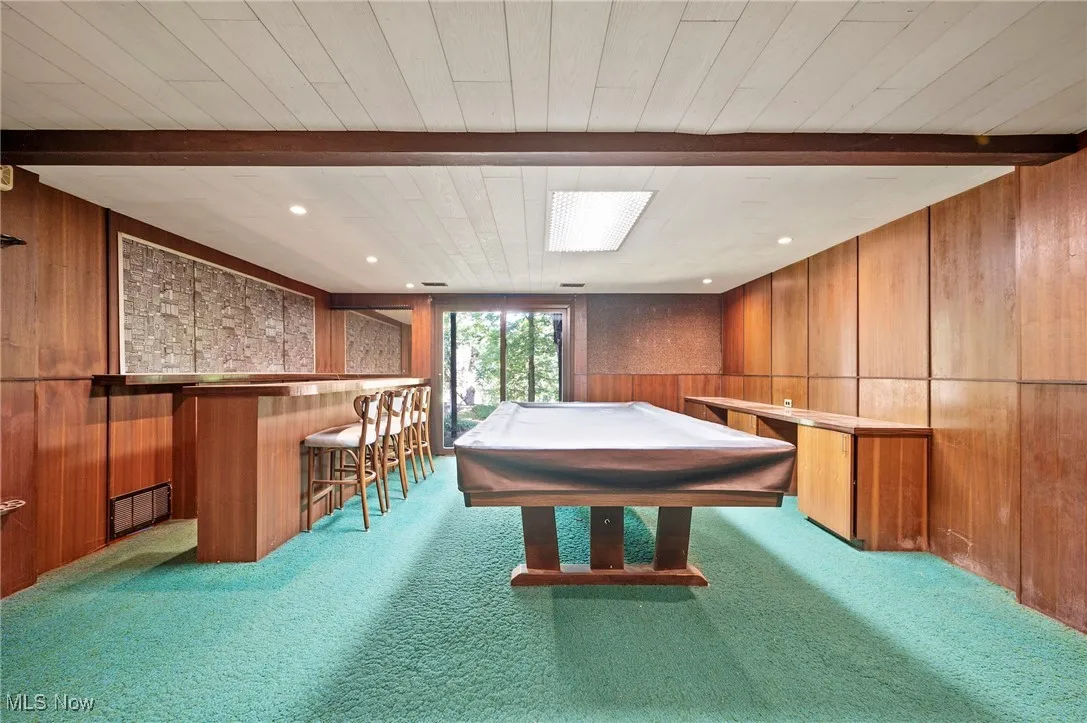 Recreation room featuring wooden walls, beam ceiling, pool table, recessed lighting, and carpet floors