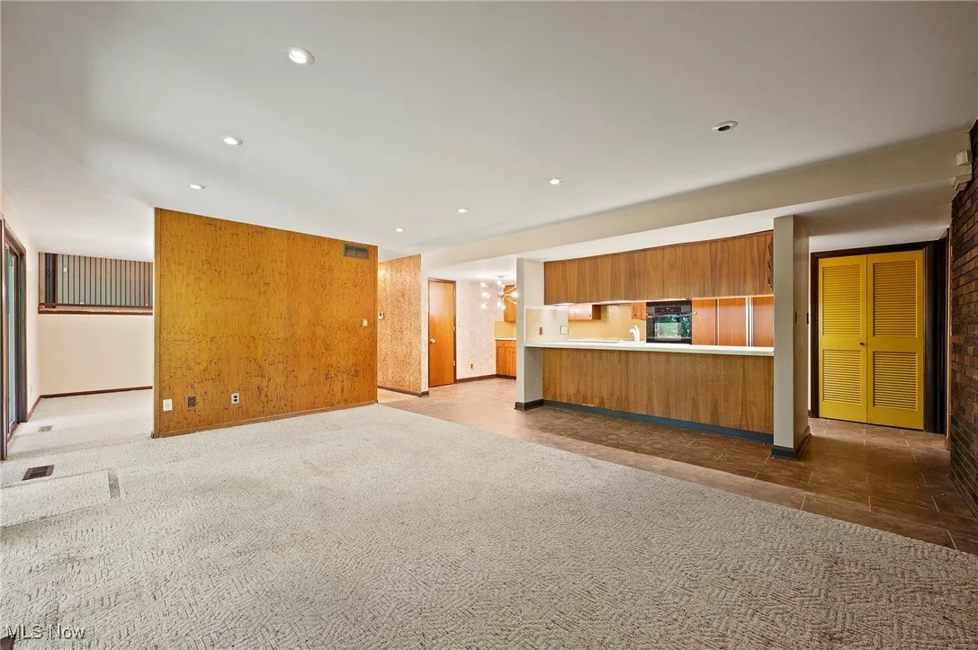 Unfurnished living room with light carpet and recessed lighting