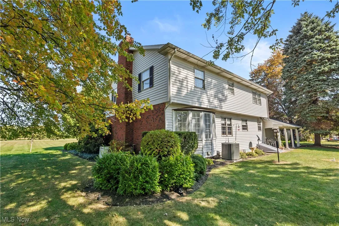 Back of house featuring a yard and a chimney