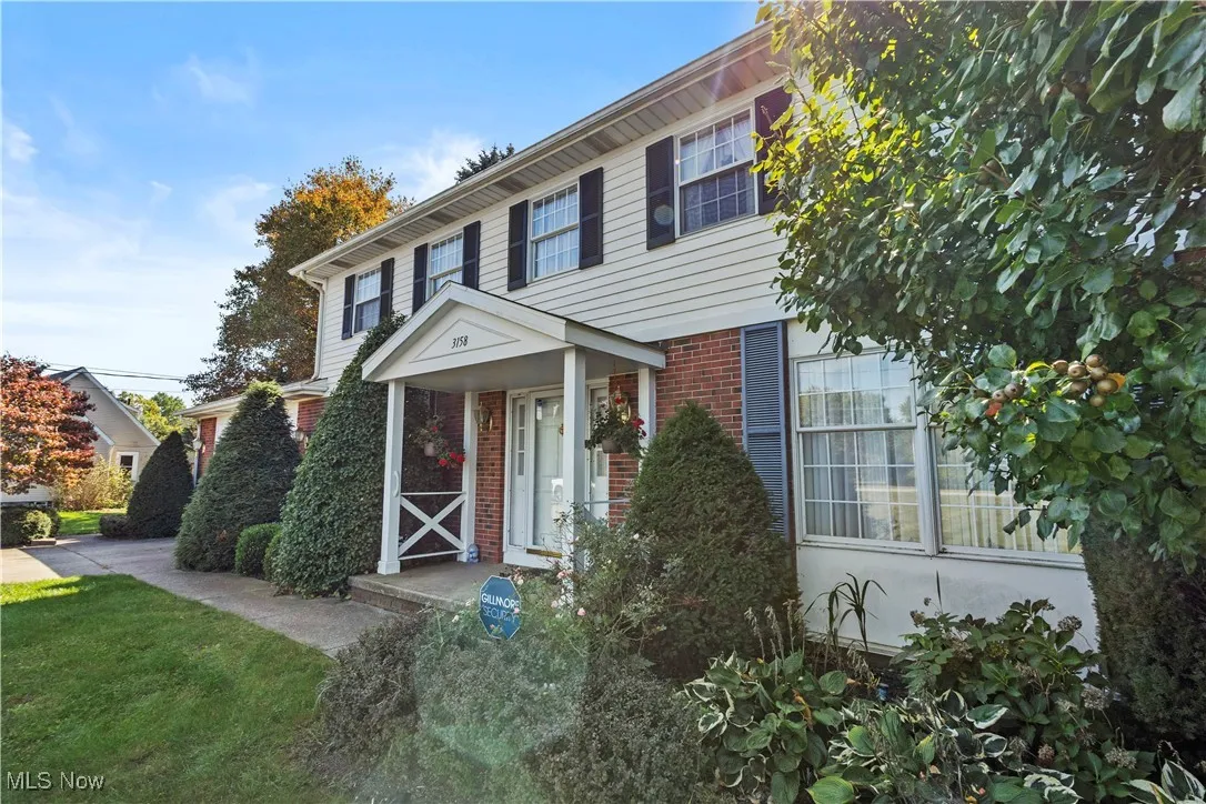 View of front of home with brick siding and a front yard