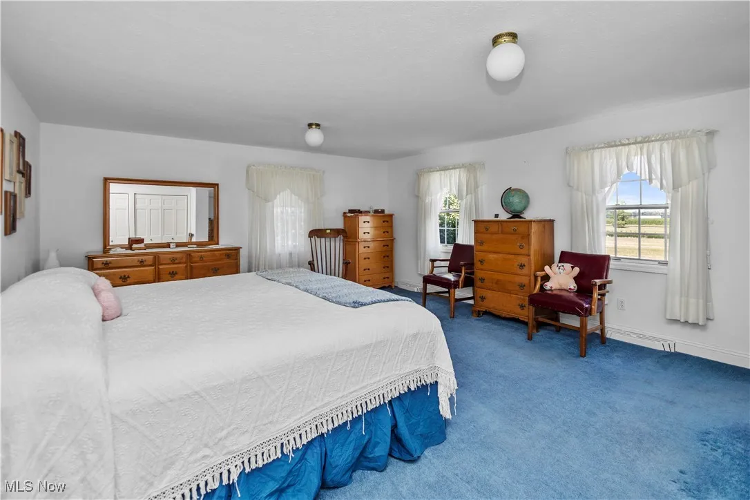 Bedroom featuring carpet flooring and baseboards