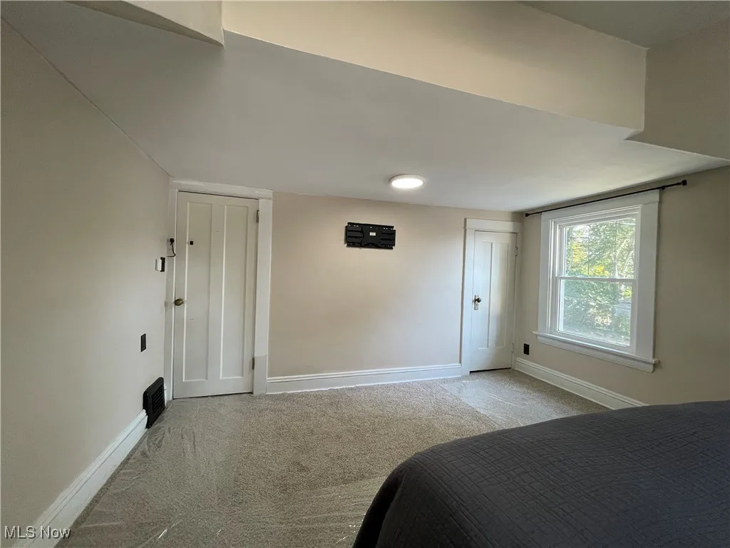 Bedroom with light colored carpet
