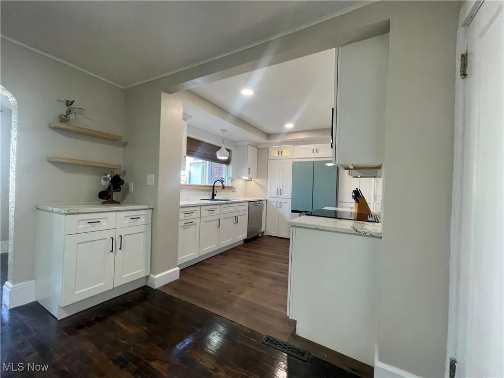 Kitchen featuring white cabinetry, dark wood finished floors, recessed lighting, light stone counters, and dishwasher