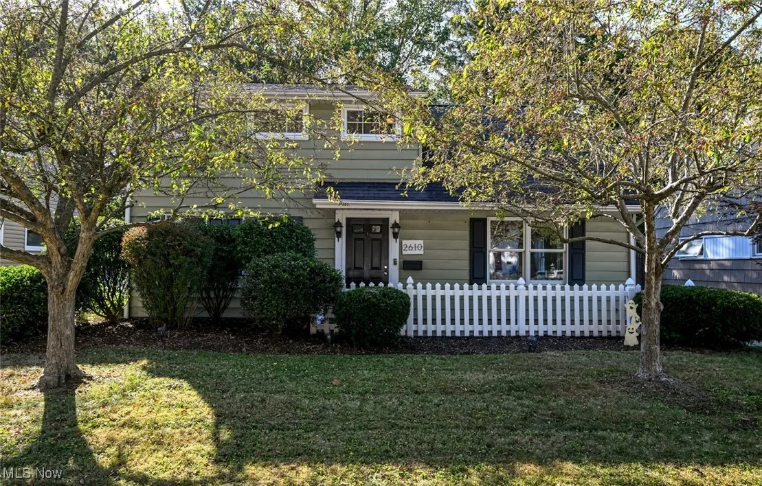 View of front of home featuring a fenced front yard and covered porch
