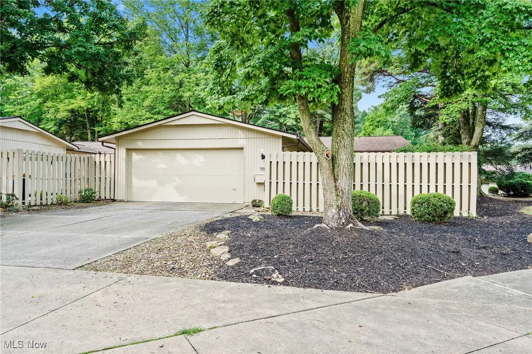 View of front of house featuring a garage and concrete driveway