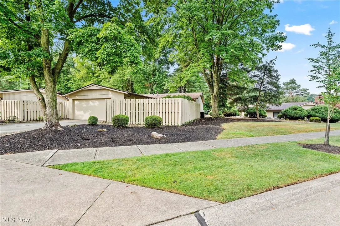 View of yard with a garage and view of scattered trees