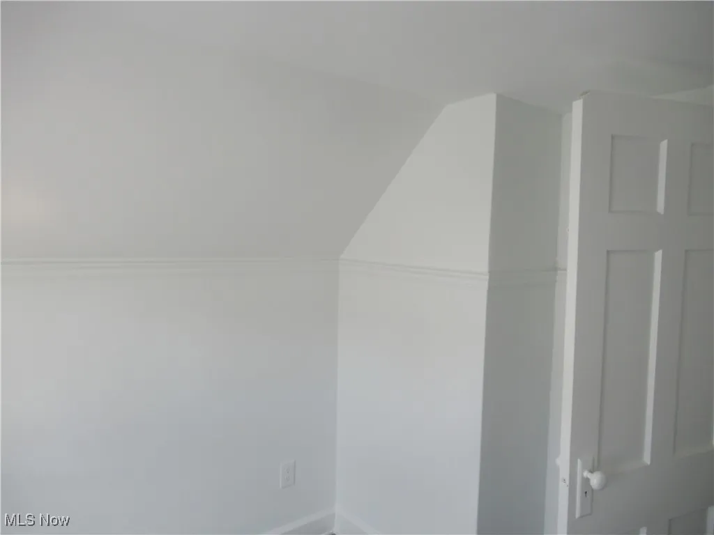 Bonus room featuring vaulted ceiling and baseboards