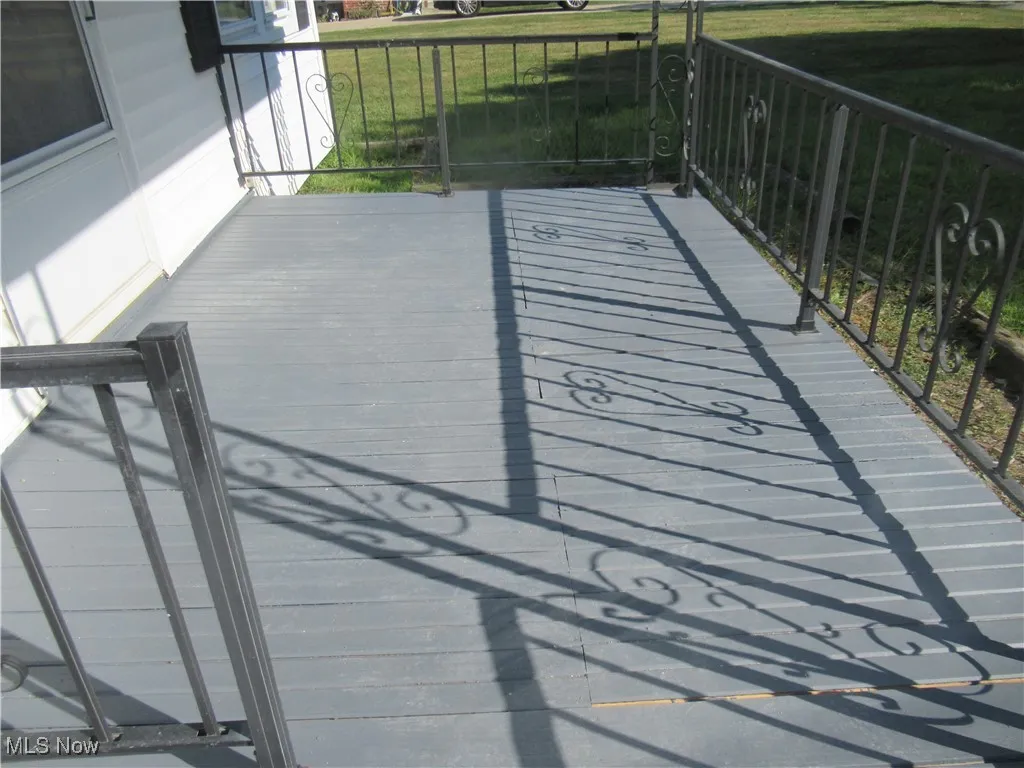 Wooden terrace featuring a yard