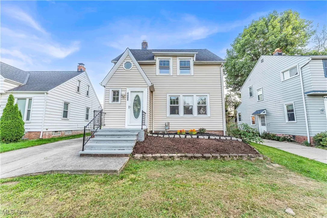 View of front facade featuring a front lawn and a chimney