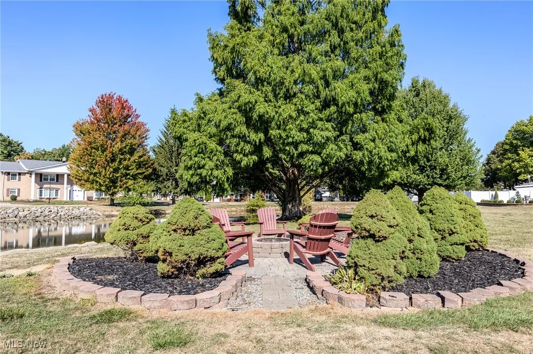 View of yard featuring a water view, a patio area, and an outdoor fire pit