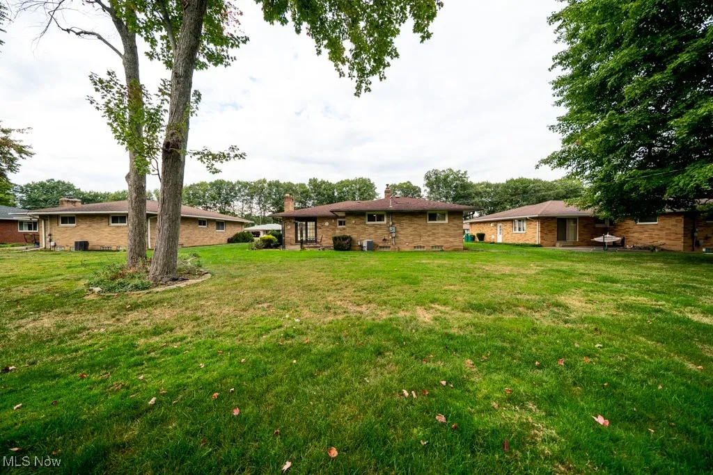 View of green lawn featuring a patio area