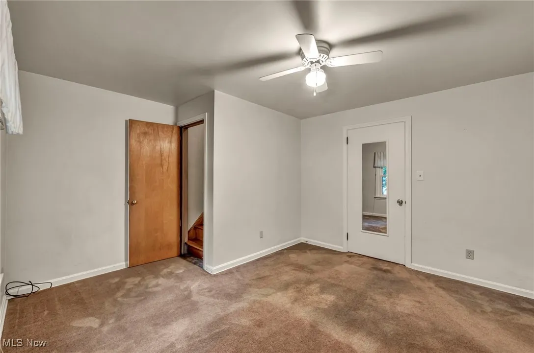 Upstairs bedroom 4 with carpet and ceiling fan with access to attic (Bonus Room)
