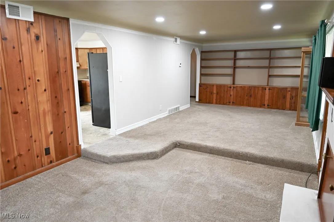 Living room featuring built in book shelves