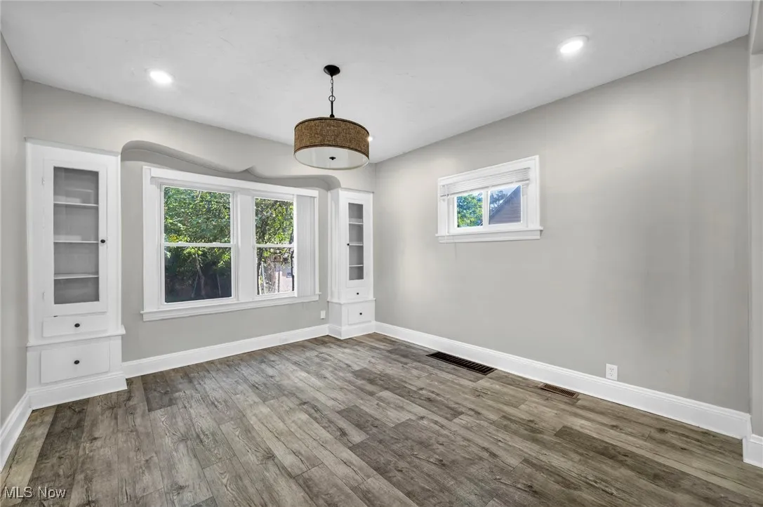 Empty room with wood finished floors and recessed lighting