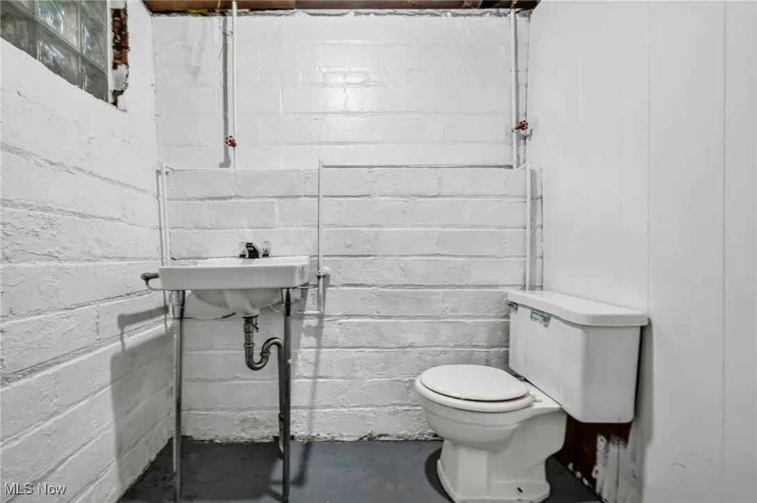 Bathroom featuring toilet and concrete flooring