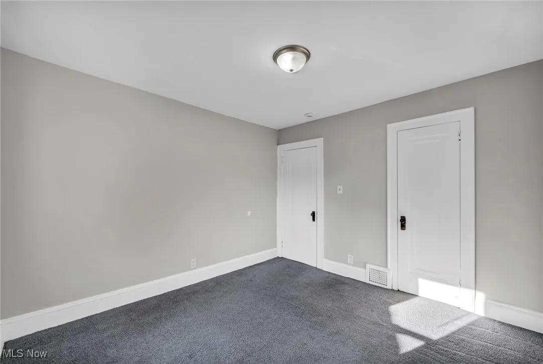 Unfurnished bedroom featuring carpet flooring and baseboards