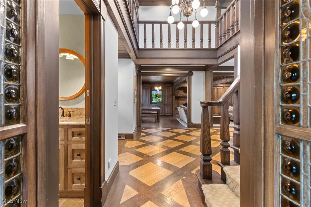 Wine area featuring inlaid floor details and a chandelier