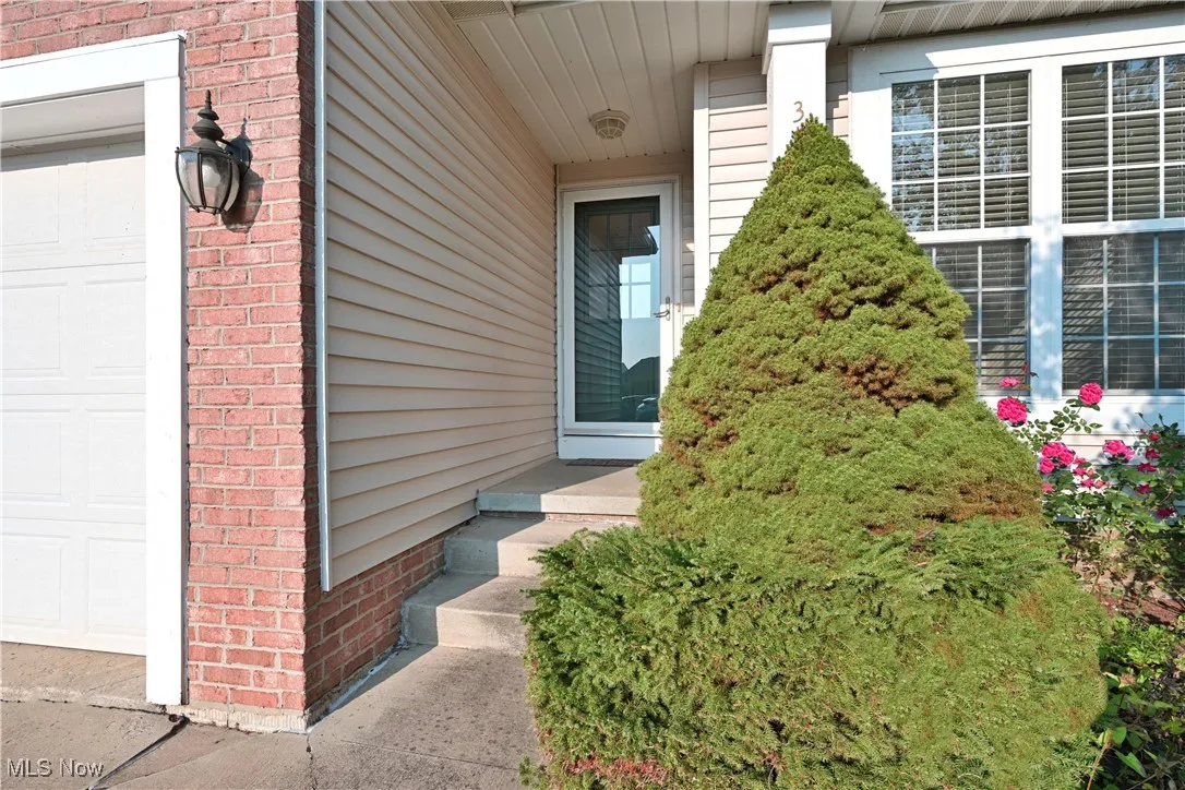 Entrance to property featuring brick siding