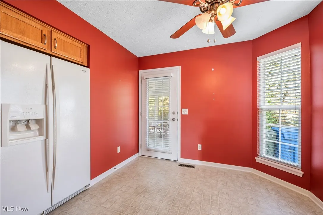 Refrigerator and eating area leading to sun room