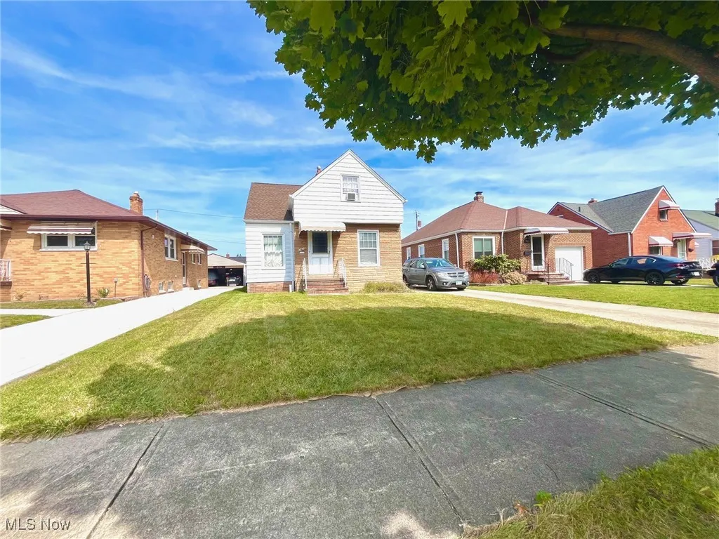 Bungalow with a front yard and driveway