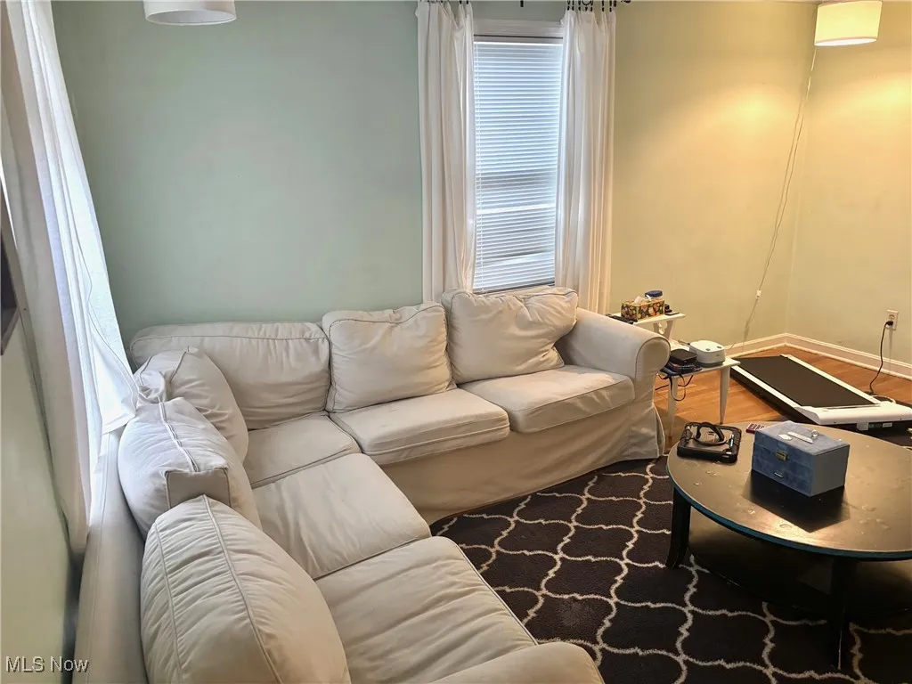 Living area with wood finished floors and baseboards