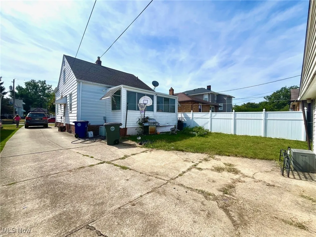 Rear view of property with driveway