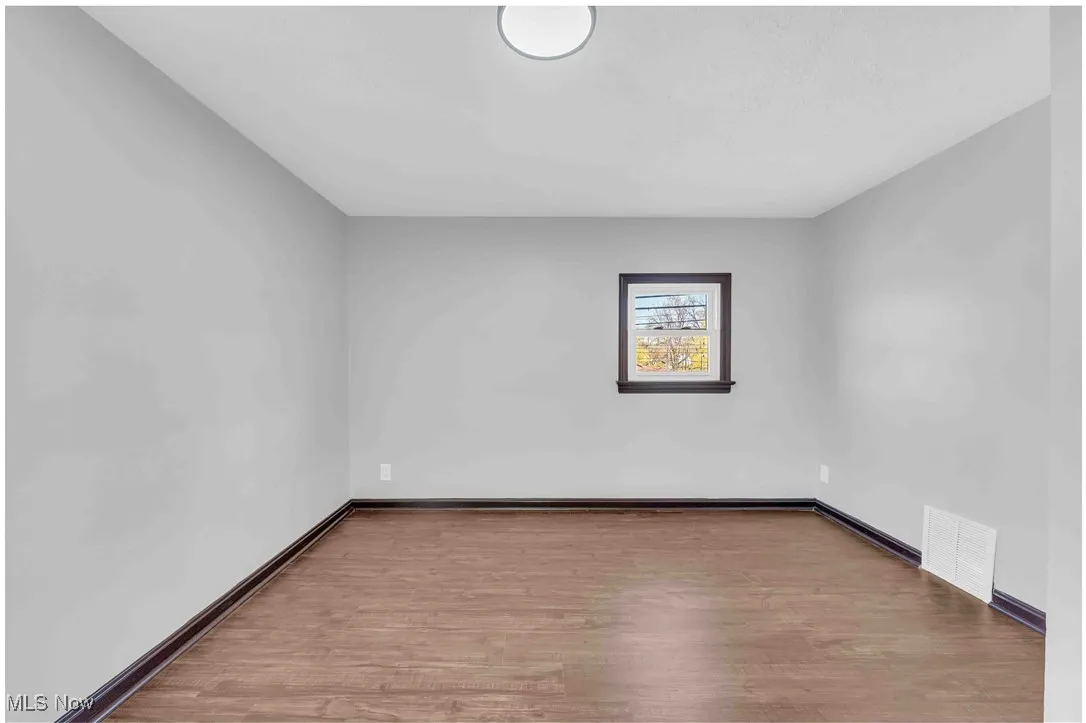 Spare room with wood finished floors and baseboards