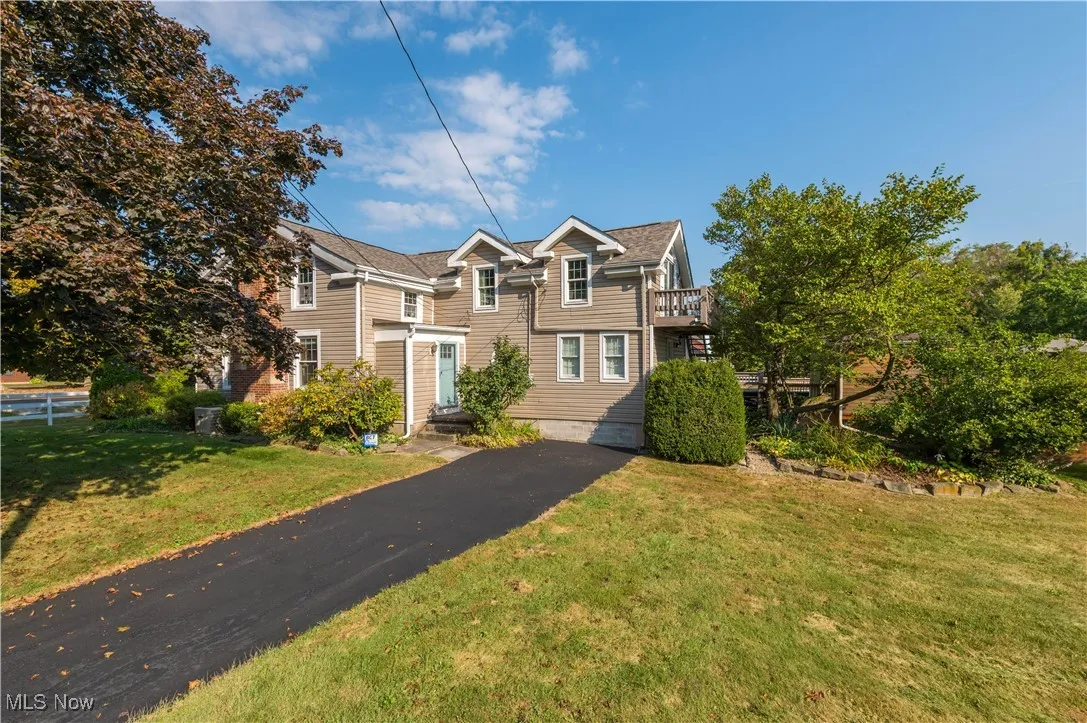 Traditional-style house with a front yard