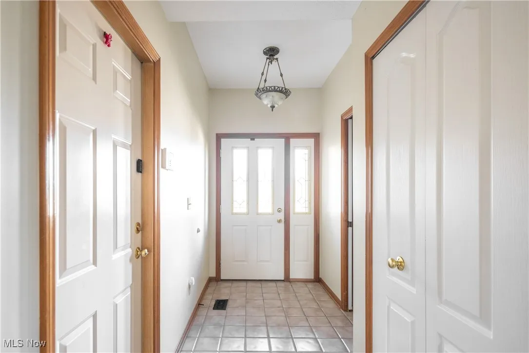 Entryway featuring tile patterned flooring and baseboards