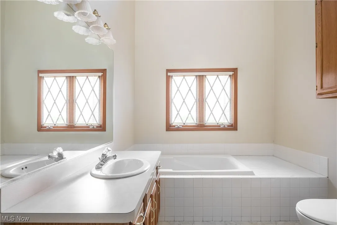 Full en-suite master bathroom featuring a spacious tub