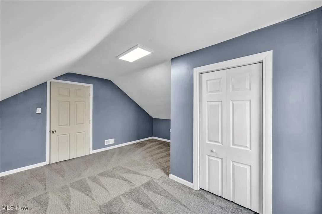 Bonus room featuring carpet floors and lofted ceiling