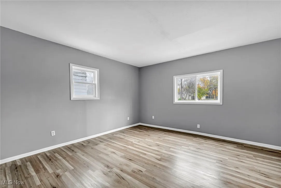Spare room with light wood-type flooring and baseboards