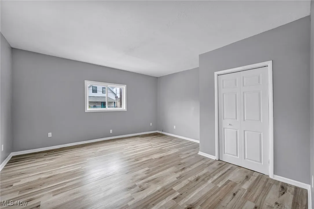 Unfurnished bedroom with light wood-style flooring and a closet