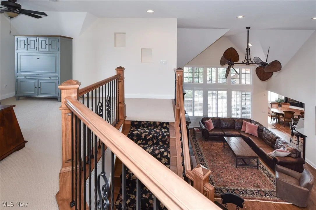 Living room featuring recessed lighting, ceiling fan, high vaulted ceiling, and light colored carpet